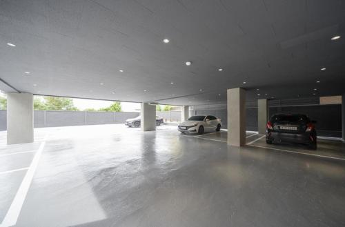 a garage with two cars parked in it at No 25 Hotel Namgumi Branch in Chilgok