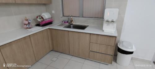a kitchen with a sink and a toilet in it at Mellgyp Homestay Bangi Kajang in Kajang