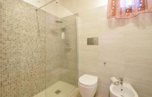 a bathroom with a shower and a toilet and a sink at Gorgeous Apartment In Solferino in Solferino
