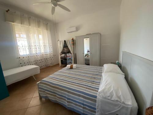 a bedroom with a bed and a ceiling fan at Dream Home in Nardò