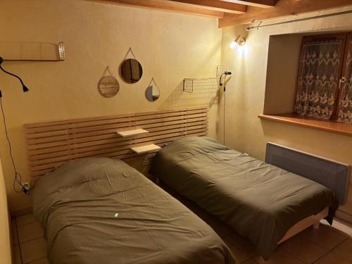 a room with two beds in a room at Gîte authentique 6 pers à Marols avec grand jardin - FR-1-496-1 in Marols