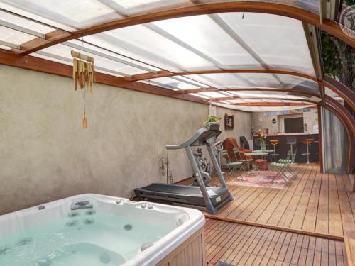 a room with a hot tub and a gym at Gîte de charme avec spa, sauna et jardin privatif à Montbrison - FR-1-496-309 in Montbrison