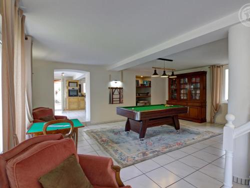 a living room with a pool table in it at Gîte de charme avec spa, sauna et jardin privatif à Montbrison - FR-1-496-309 in Montbrison