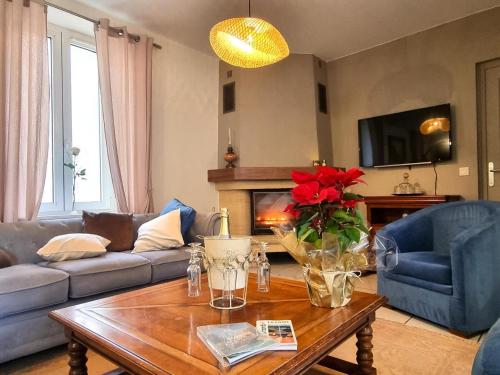 a living room with a couch and a table at Gîte de charme avec spa, sauna et jardin privatif à Montbrison - FR-1-496-309 in Montbrison