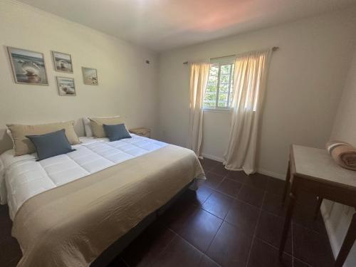a bedroom with a large white bed and a window at La Colorada Dolores in Dolores