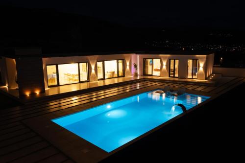 a swimming pool on a deck at night at Golden View Villa Sauna & Spa in Blagaj