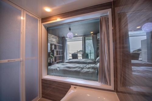 a bedroom with a large mirror on the wall at MARINE-Q in Inami