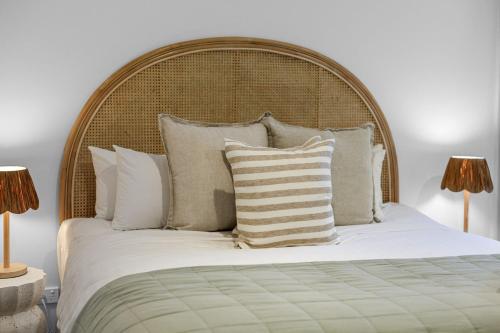 a bedroom with a large bed with white sheets and pillows at La Dolce Vita in Port Fairy