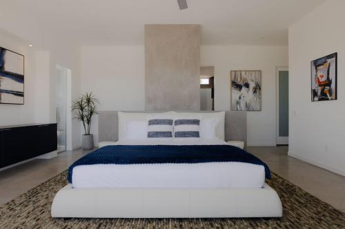 a large white bedroom with a large white bed at Orchid by Fieldtrip Architectural Estate w Pool, Spa, Game Room in Yucca Valley