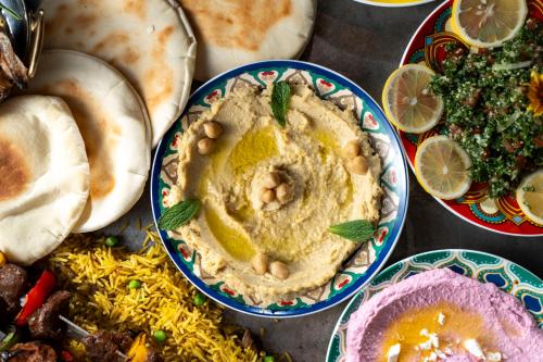 a table topped with bowls of hummus and other food at Futian Shangri-La, Shenzhen,Near to Shenzhen Convention&Exhibition Centre, Futian Railway Station in Shenzhen