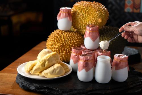 a table with a plate of food with fruit and milk at Futian Shangri-La, Shenzhen,Near to Shenzhen Convention&Exhibition Centre, Futian Railway Station in Shenzhen