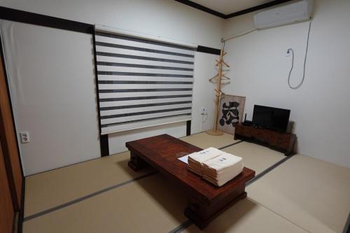 a living room with a table and a television at Private Suncheon House in Suncheon