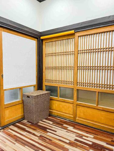 a room with a large window and a wicker stool at Private Suncheon House in Suncheon