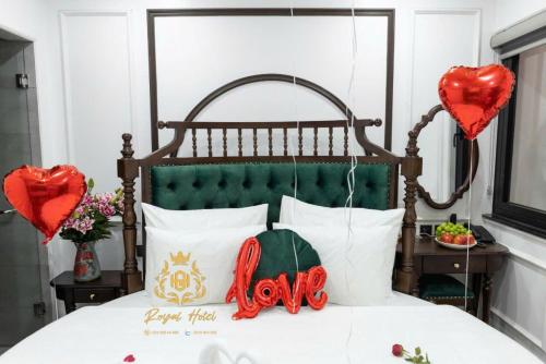 a bedroom with a bed with two red hearts at Royal Hotel Kangnam in Hanoi