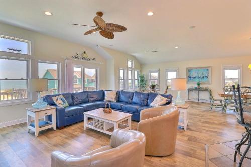 a living room with a blue couch and chairs at 7076 - JMJ Seascape in Nags Head