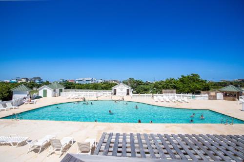 a large pool with chairs and people in it at 8074 - Sea Glass Charmer in Avon