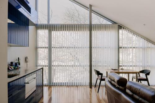 a kitchen with a large window with a table and chairs at Salamanca Wharf Hotel in Hobart