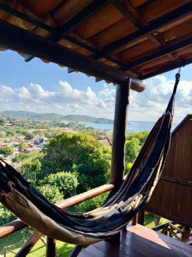 a hammock on a porch with a view at Pousada Janellas do Mar in Búzios