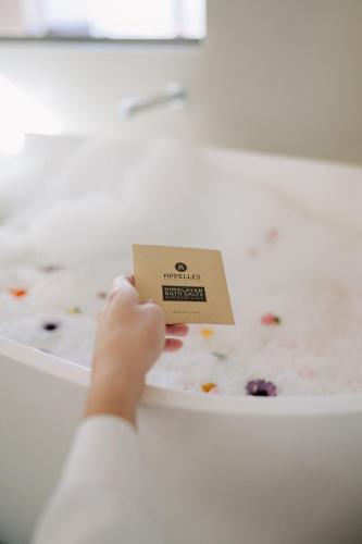 a person holding a card in front of a box of food at Salamanca Wharf Hotel in Hobart