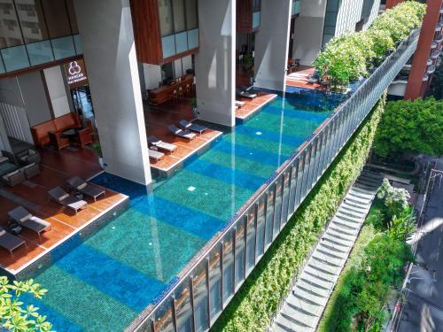 an overhead view of a swimming pool in a building at Hansar Bangkok Hotel in Bangkok