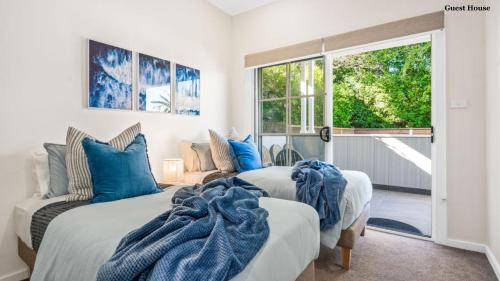 a bedroom with two beds and a window at Trio by the Sea in Forster