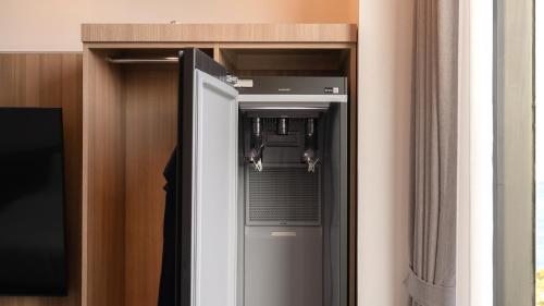 a elevator in a room with a glass door at The Van Hotel in Ulsan