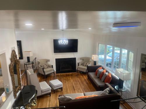 a living room with a couch and a fireplace at Entire 5 Bedrooms Home near DC and Metro in Silver Spring