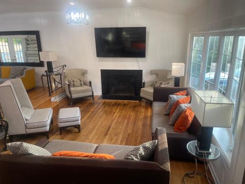 a living room with a couch and a fireplace at Entire 5 Bedrooms Home near DC and Metro in Silver Spring