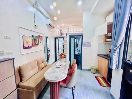 a small living room with a table and a couch at Lilo's Homestay West Lake Thuy Khue in Hanoi