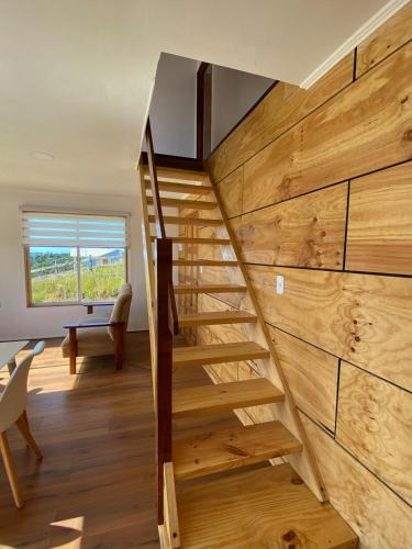 a staircase in a house with wooden walls at Cabaña puesta de sol in Ancud