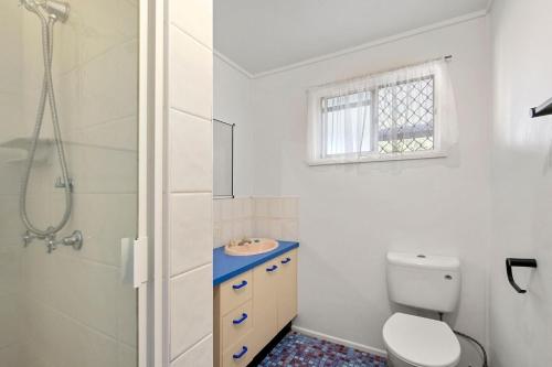 a bathroom with a toilet and a sink and a shower at Gothic Pde 16, Currimundi in Kawana Waters