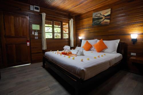 a bedroom with a bed with flowers on it at Chareena Beachside in Ko Lipe