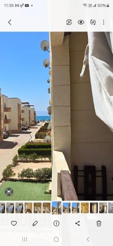 a view of a building with a bench and the ocean at شالية مكيف غرفتين,ولفنج ,وحمام كامل, وتراس يرى البحر قرية بلوا لاجون 2 ليله اقل حجز عائلات فقط من فضلك in Ras Sedr
