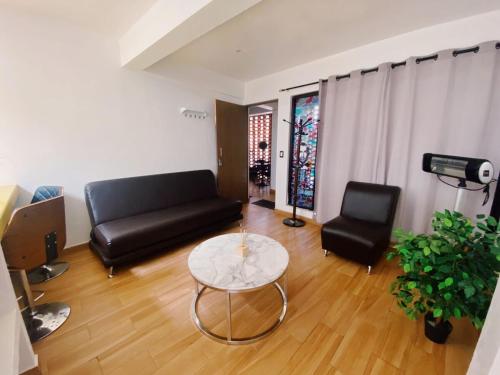 a living room with a couch and a table at The best view of the river apartments garden in Orizaba