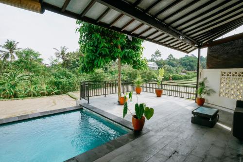 a swimming pool in the middle of a house at Uma Jala Villa Ubud in Ubud