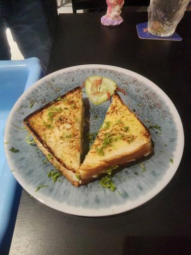 a white plate with a piece of food on a table at Captain Hotel Cafe & Bistro in Sitiawan