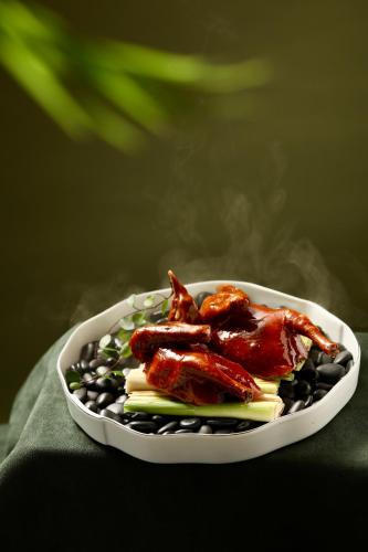 a plate of food with chicken wings and vegetables at Park Hyatt Shenzhen in Shenzhen