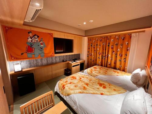 a hotel room with two beds and a tv at Henn na Hotel Premier Kyoto Gojo Karasuma -Formerly Watermark Hotel Kyoto- in Kyoto