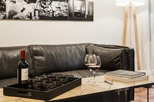 a table with a bottle of wine and a glass at Apart Hotel B in Santiago