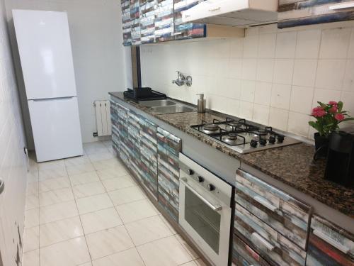 a kitchen with a stove and a counter top at Nice and sunny apartment near Barcelona in Mollet del Vallès