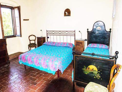 una camera con due letti e una sedia di Apartment in Modigliana with swimming pool a Modigliana