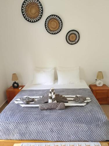 a bedroom with a bed with three plates on the wall at Masaya Retreat Lombok in Kuta Lombok