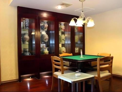 a dining room with a ping pong table and chairs at Juntong Hotel in Bao'an