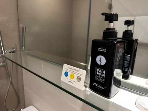a bottle of hairologne sitting on a glass counter at F1 Hotel Manila in Manila