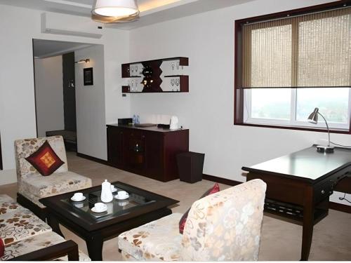 a living room with a couch and a table at BMC Ha Tinh hotel in Ha Tinh