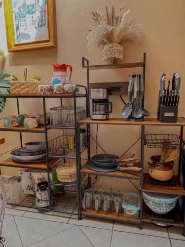 a shelf with plates and utensils on it at Departamento Santa Fe (totalmente nuevo) in Taxco de Alarcón