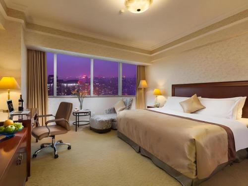 a hotel room with a large bed and a large window at Jiaxing Sunshine Hotel in Jiaxing