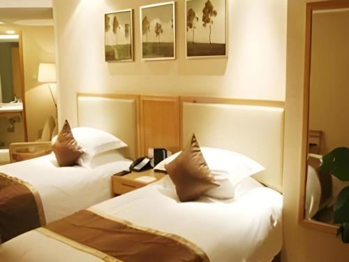 a hotel room with two beds and a telephone at Jinhua World Trade Hotel in Jinhua