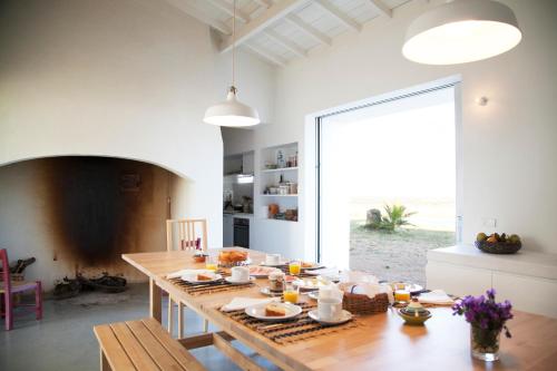 a dining room with a table with food on it at Monte Da Azarujinha in Azaruja