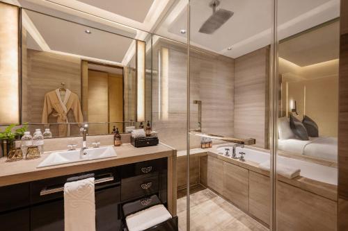 a bathroom with a sink and a shower at Kempinski The One Suites Hotel Shanghai Downtown in Shanghai